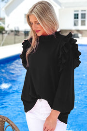 a woman standing next to a pool wearing a black top
