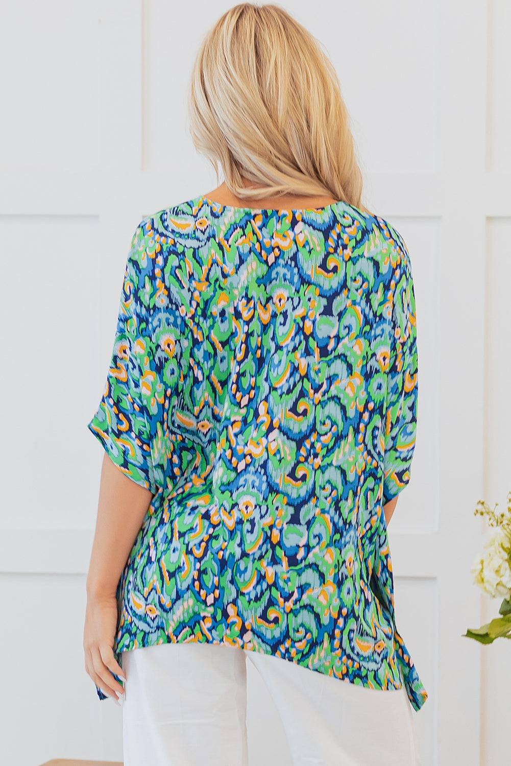 Back view of Green Abstract Print V Neck Half Sleeve Loose Fit Tunic Blouse highlighting lightweight fabric and relaxed drape for warm weather.
