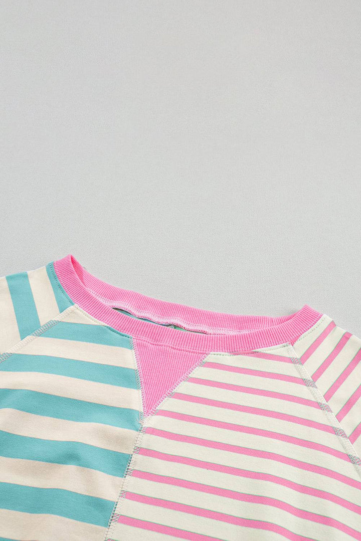 a close up of a shirt with a pink and blue stripe on it
