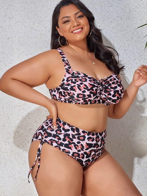 a woman in a leopard print bikini top and bottom