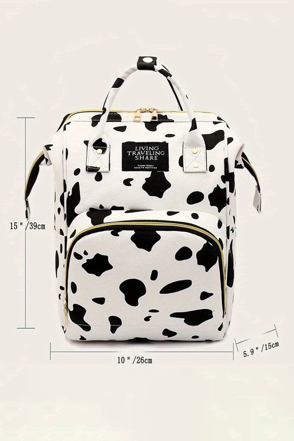 a black and white cow print backpack with measurements