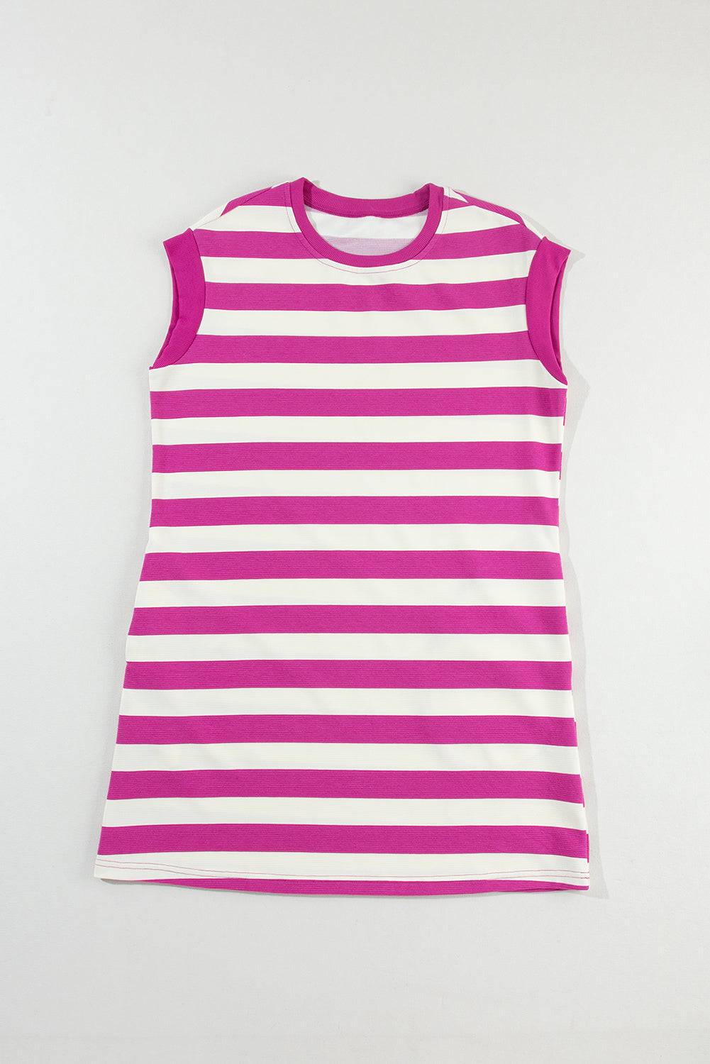 a pink and white striped top hanging on a wall