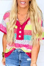 a blonde woman wearing a colorful shirt and jeans