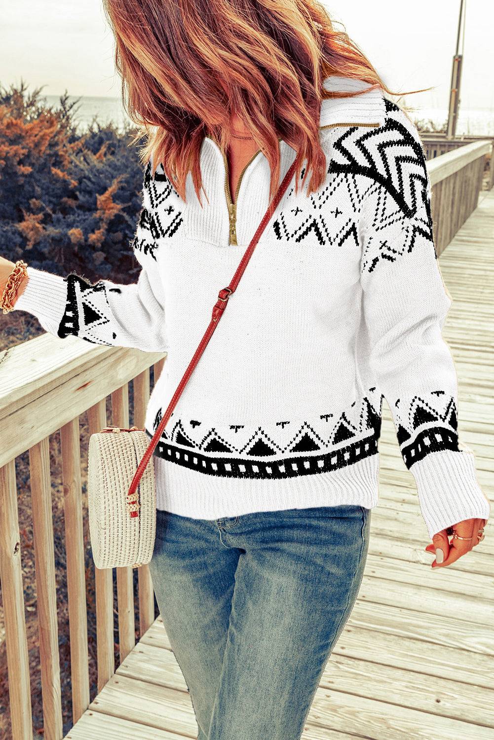 a woman walking across a wooden bridge