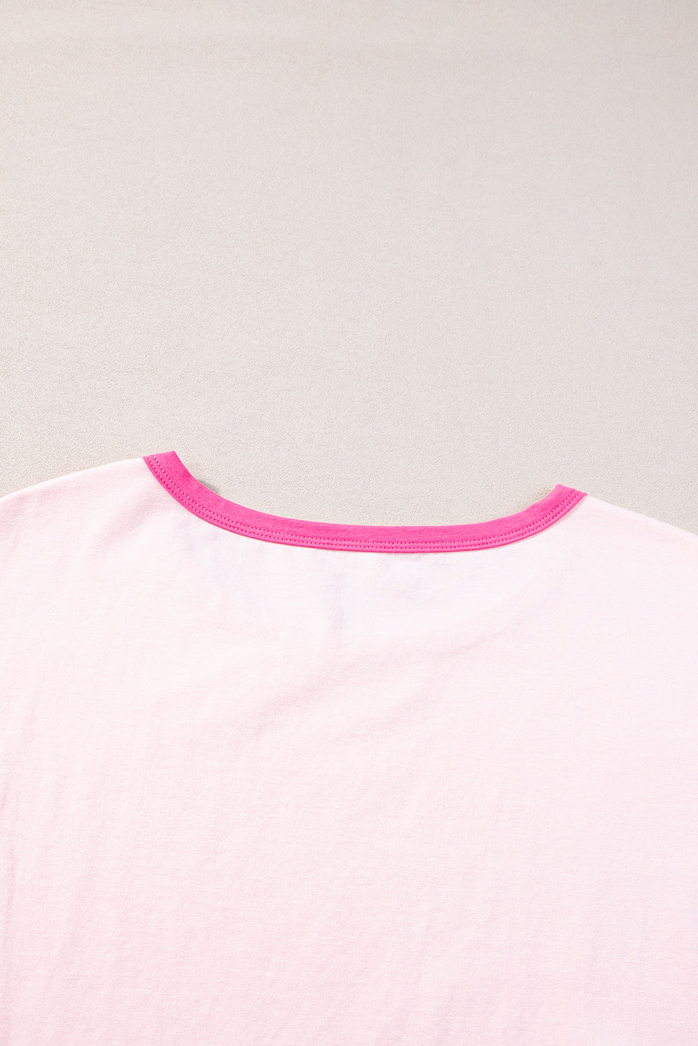 a pink t - shirt with a pink stripe on the chest