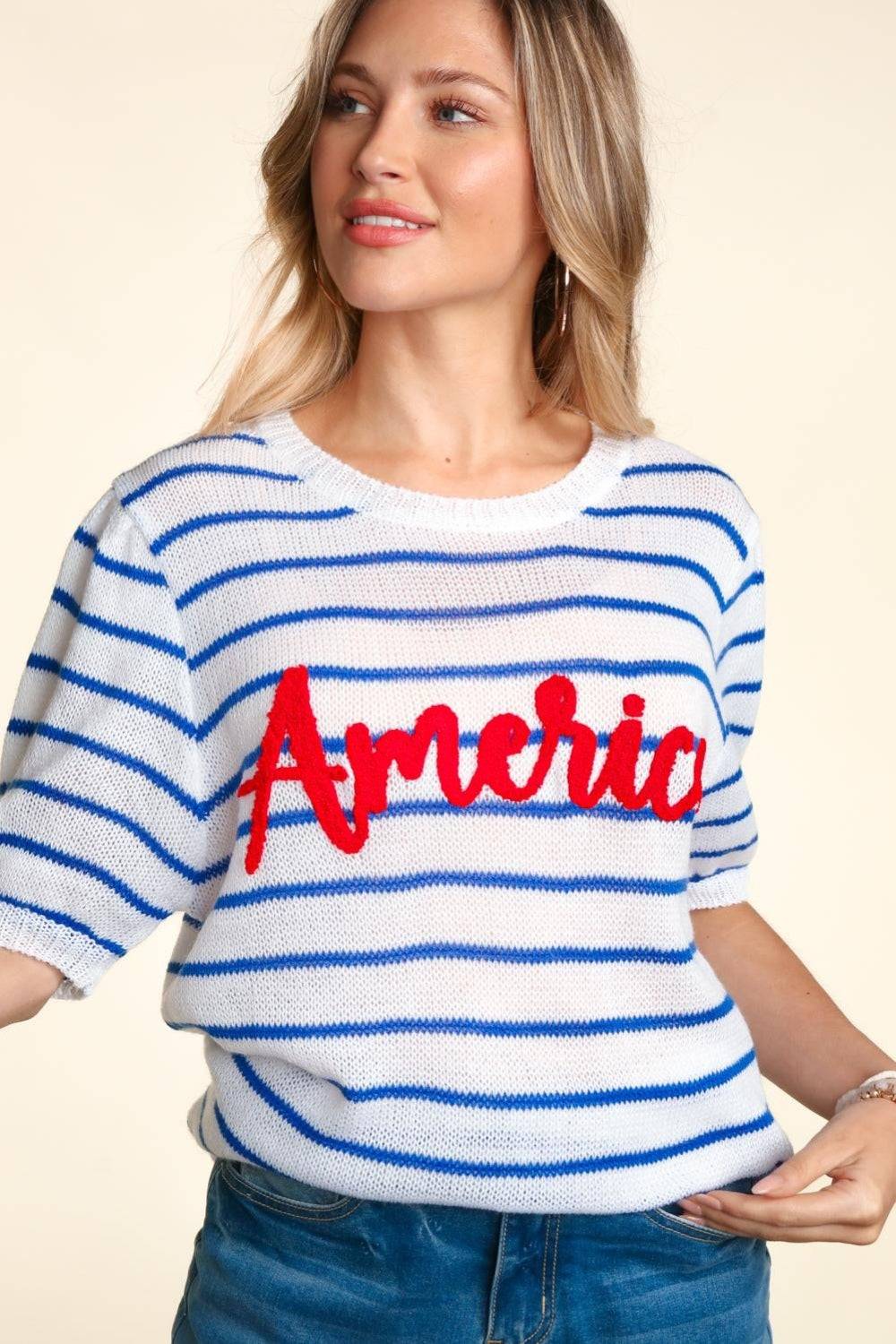 a woman wearing a sweater with the word america painted on it
