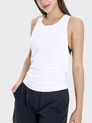 a woman wearing a white tank top and black shorts