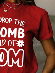 a woman wearing a red t - shirt that says drop the bomb and end of