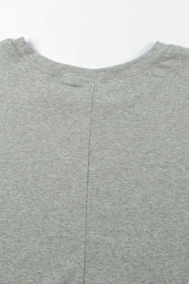 a close up of a person wearing a gray shirt