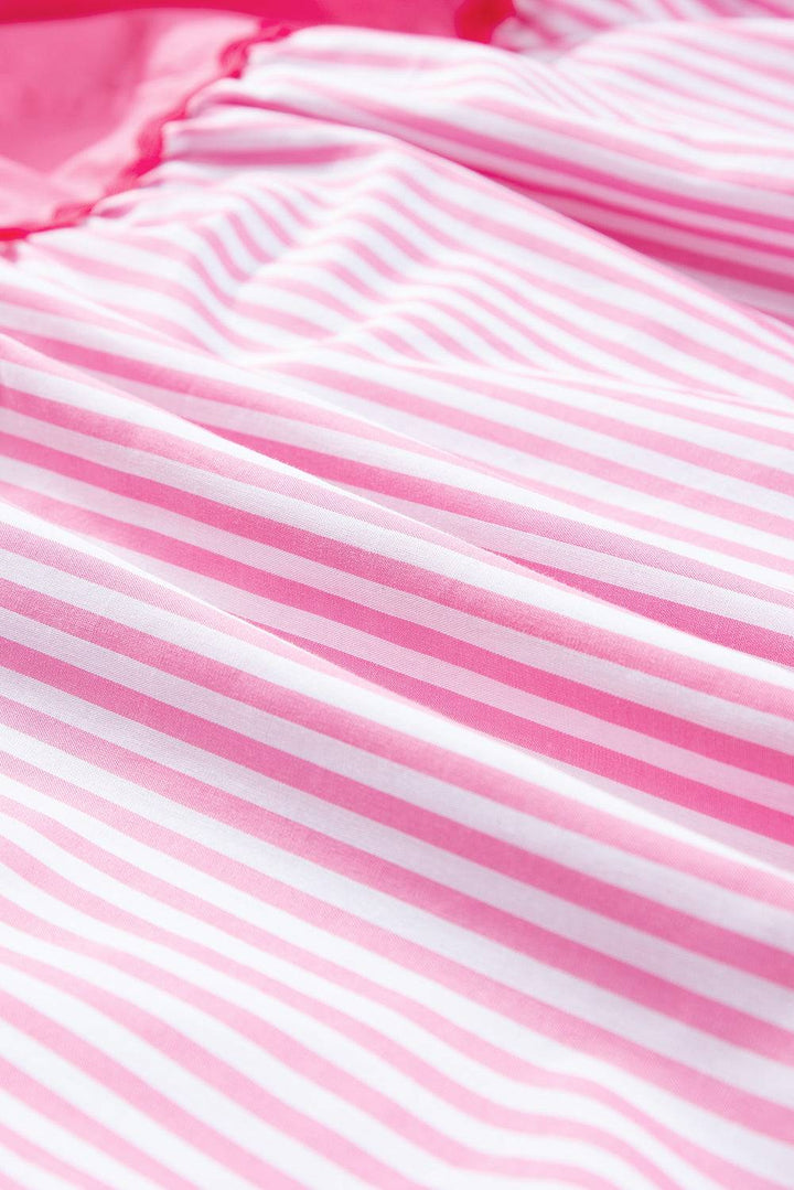 a close up of a pink and white striped shirt