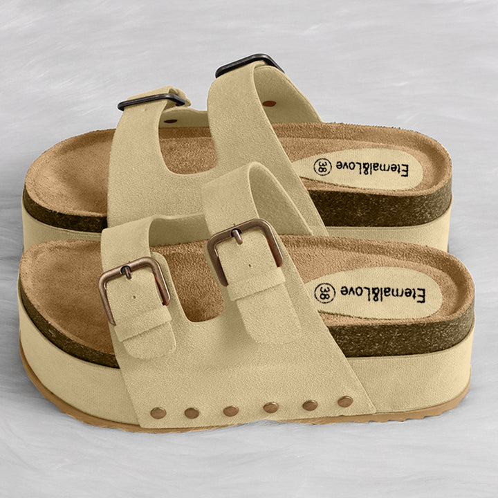 a pair of white sandals with brown straps