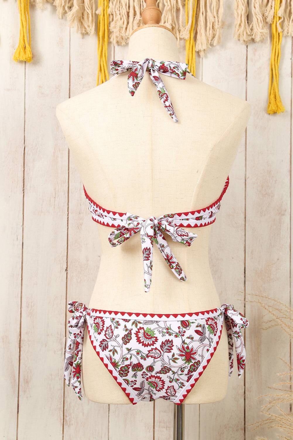 a mannequin wearing a red and white floral bikini