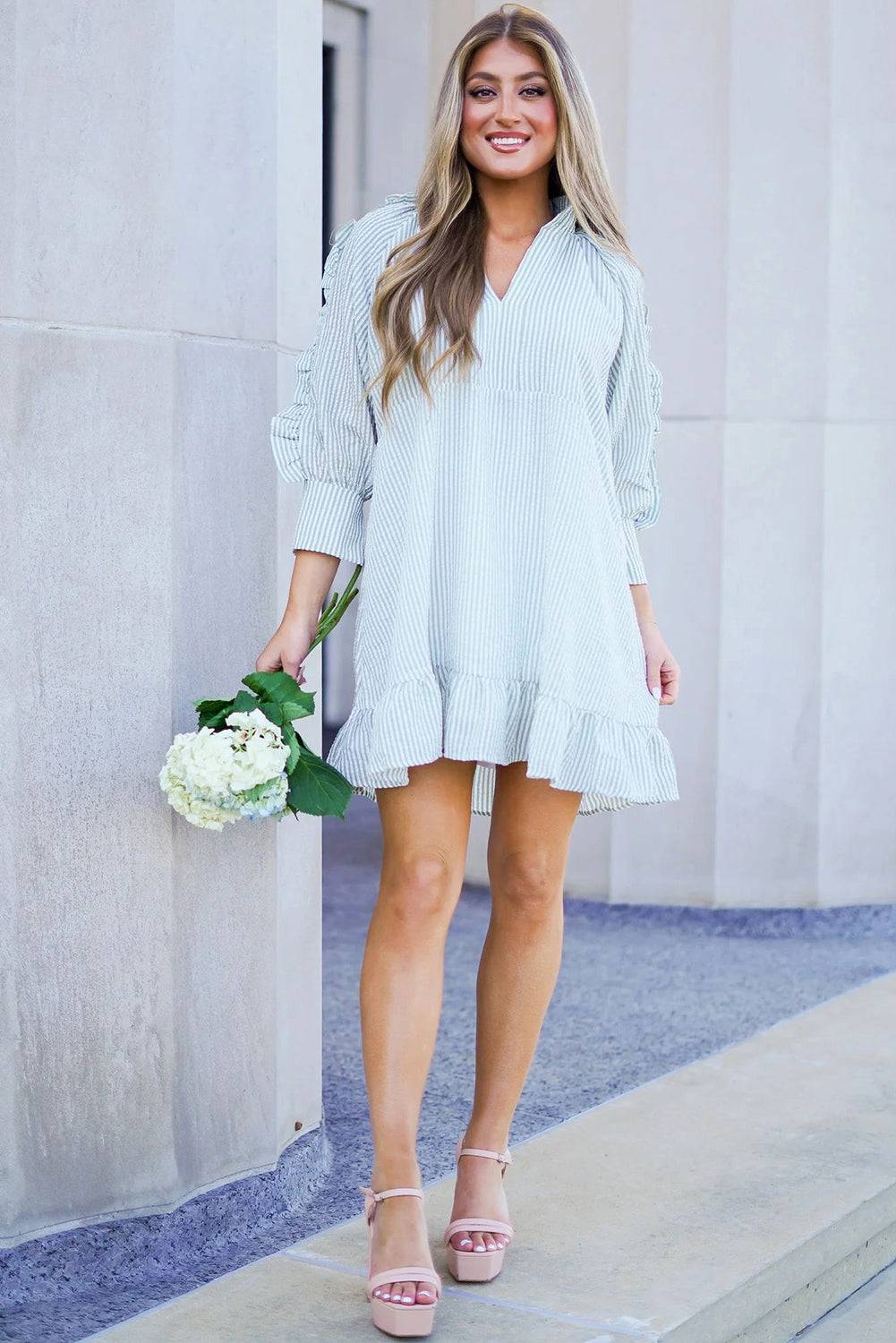 a woman in a white dress holding a bouquet of flowers