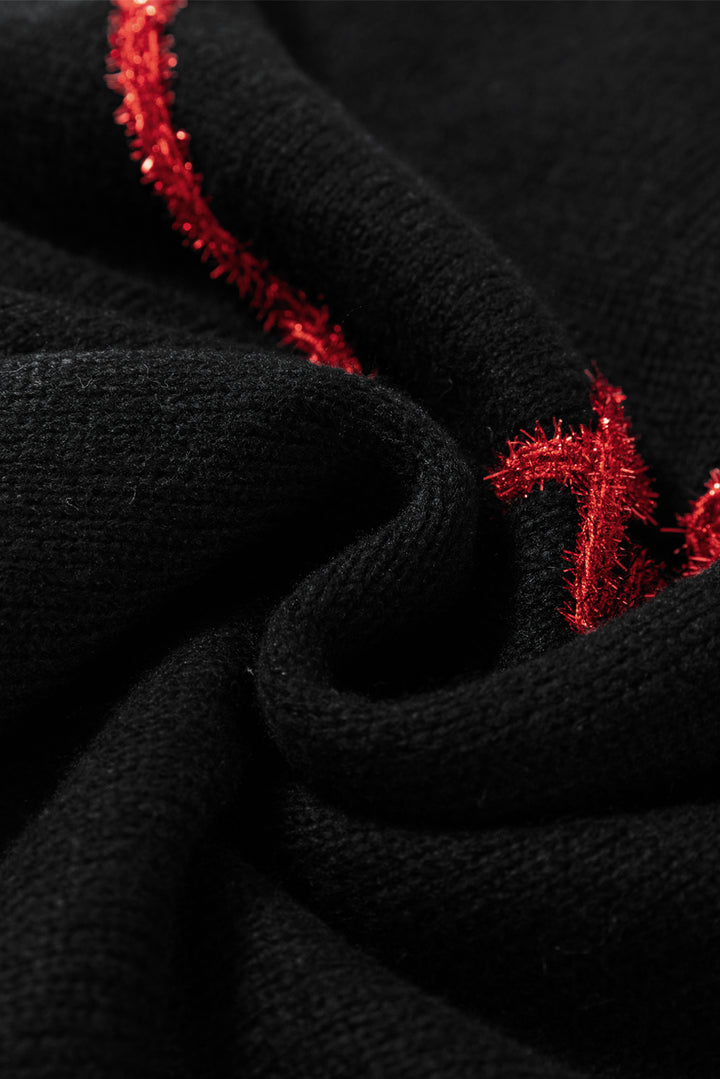 a close up of a black fabric with red sequins