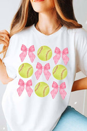 a woman wearing a white shirt with pink bows and softballs on it
