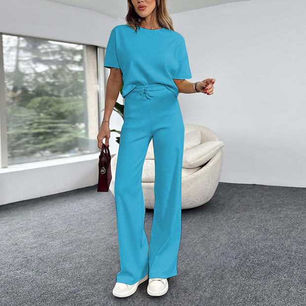 a woman in a blue jumpsuit standing in a room