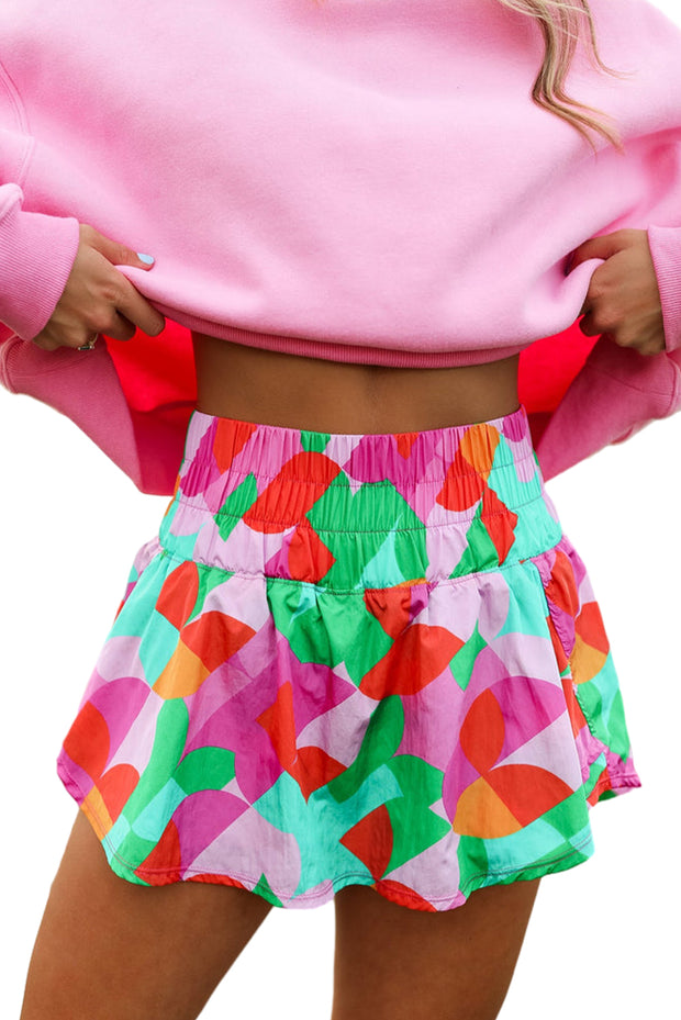 a woman wearing a pink sweater and colorful skirt