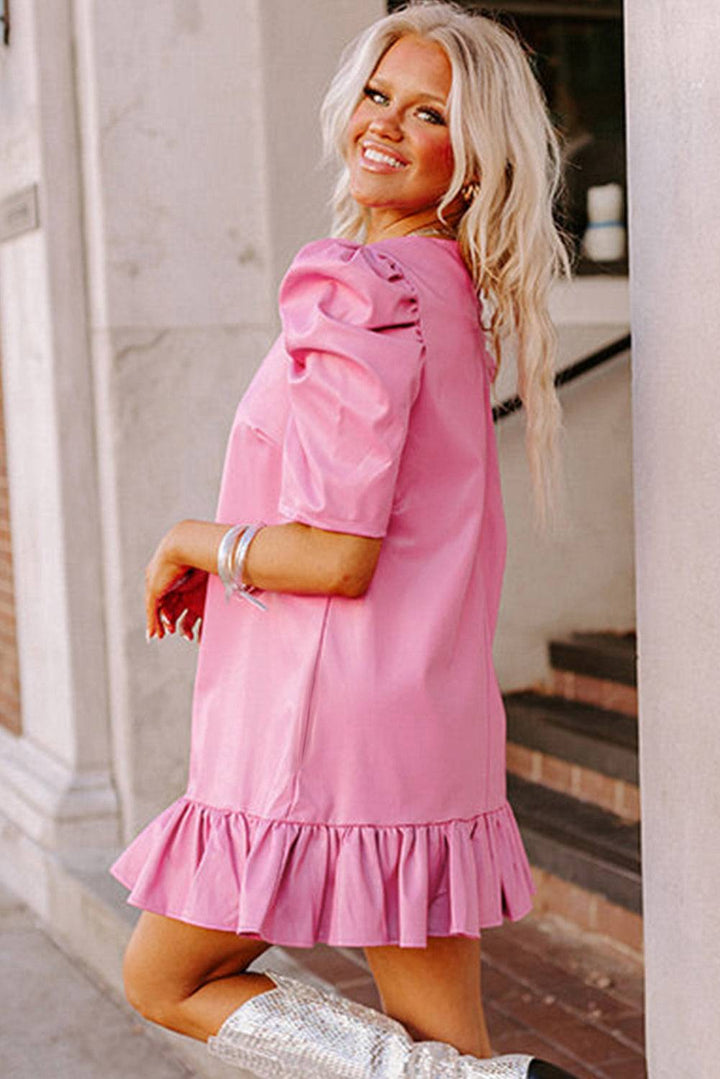 a woman in a pink dress and cowboy boots