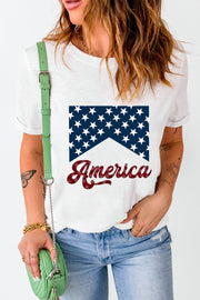 a woman holding a green purse and wearing an american t - shirt