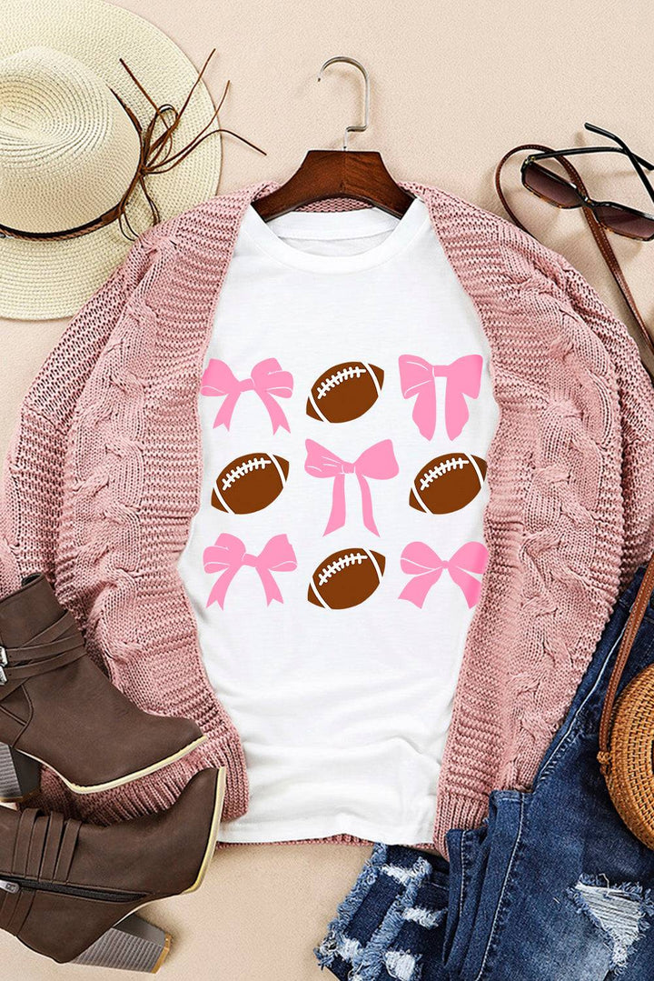 a white shirt with pink bows and footballs on it