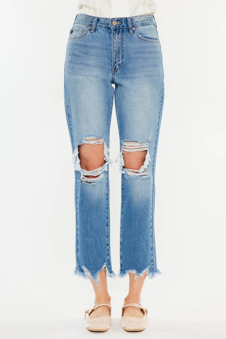 a woman wearing a pair of ripped jeans