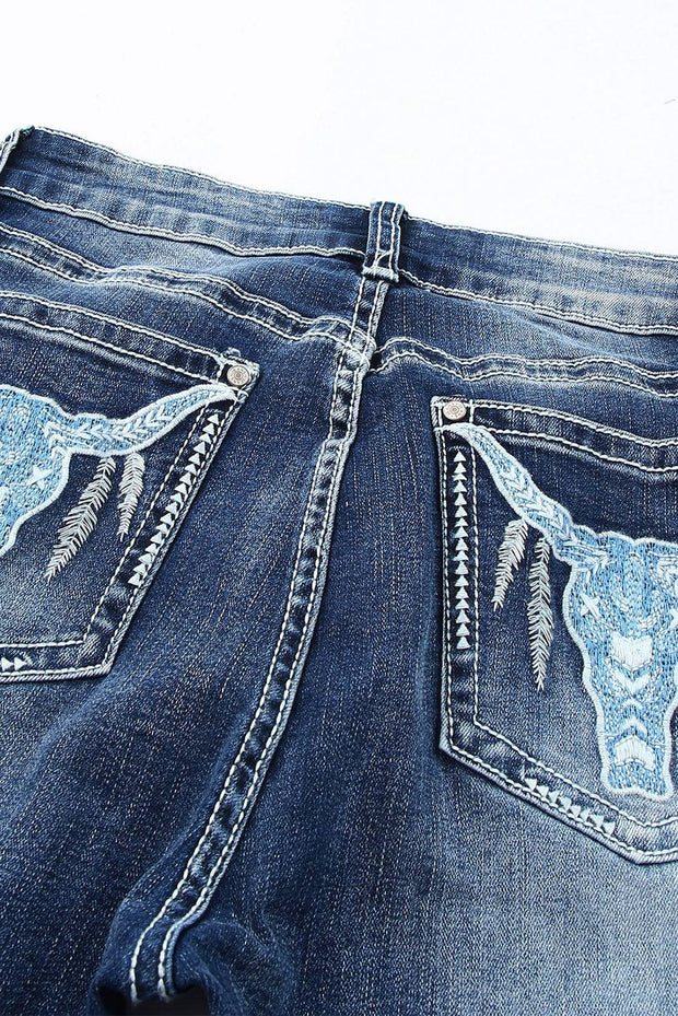 a pair of jeans with a cow skull on them
