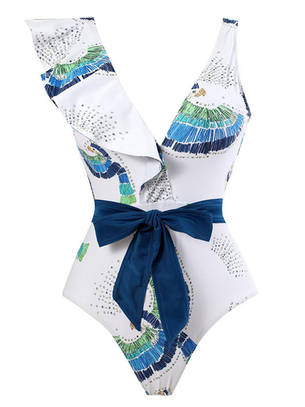 a white and blue one piece swimsuit with a blue bow