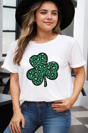 a woman wearing a white shirt with a green clover on it