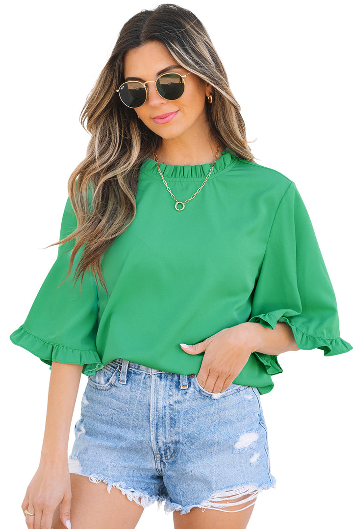 Isolated model shot in Green Frilly Round Neck Wide Half Sleeve Blouse and denim shorts, ideal for e-commerce display.