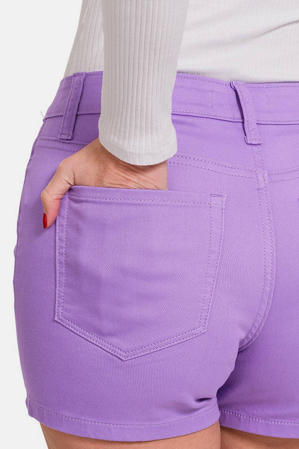 a close up of a person wearing purple shorts