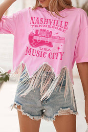 a woman wearing a pink nashville t - shirt