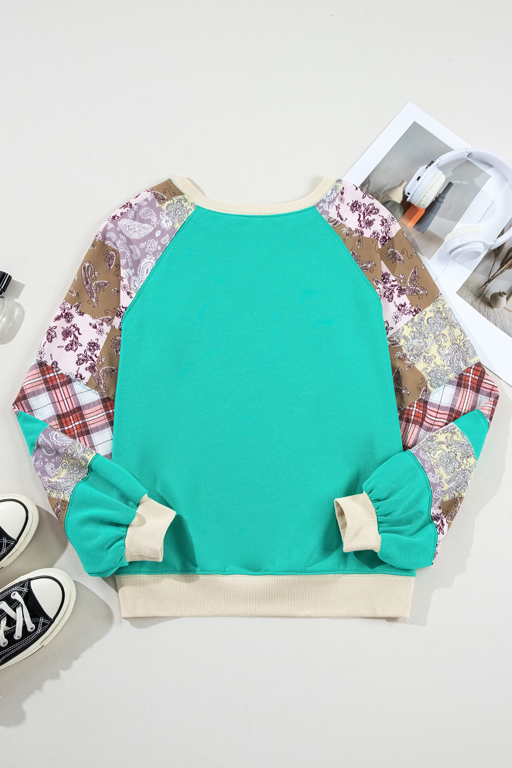 Back flat lay of Aruba Blue Plaid Vintage Paisley Patchwork Long Sleeve Raglan Top showing sleeve design. Shop at Faith & Co. Boutique.