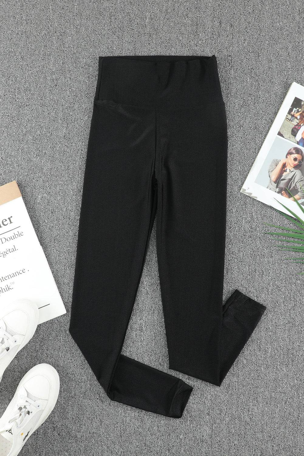 a pair of black leggings next to a magazine