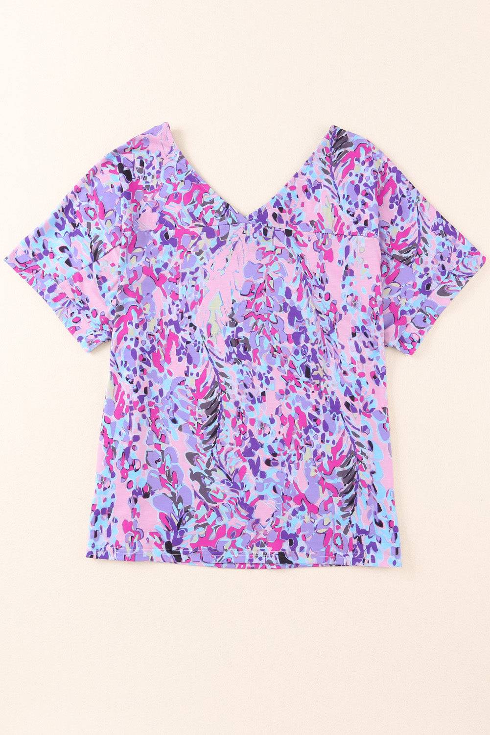 a pink and blue top with a floral pattern