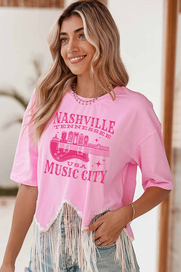 a woman wearing a pink nashville t - shirt