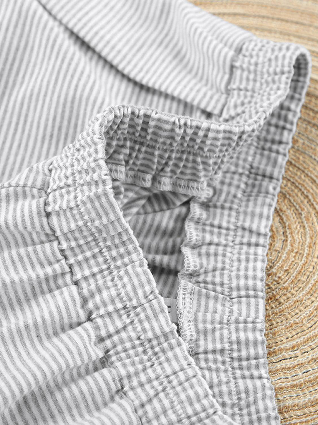 a close up of a shirt on a woven mat
