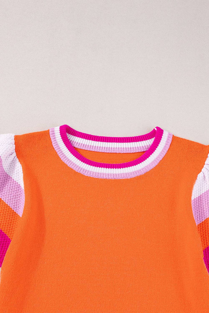 an orange shirt with pink and white stripes