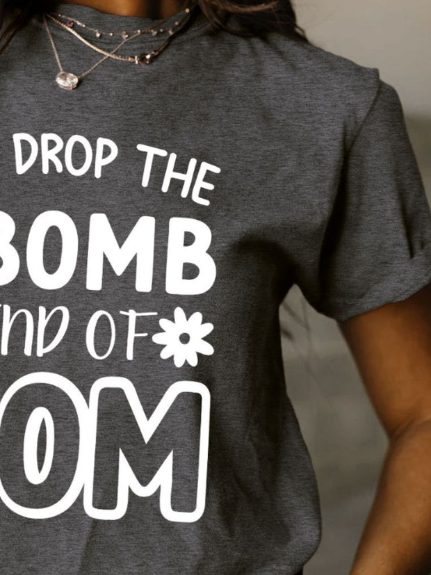 a woman wearing a t - shirt that says drop the bomb and of mom