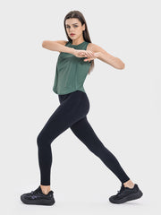 a woman in a green top and black leggings