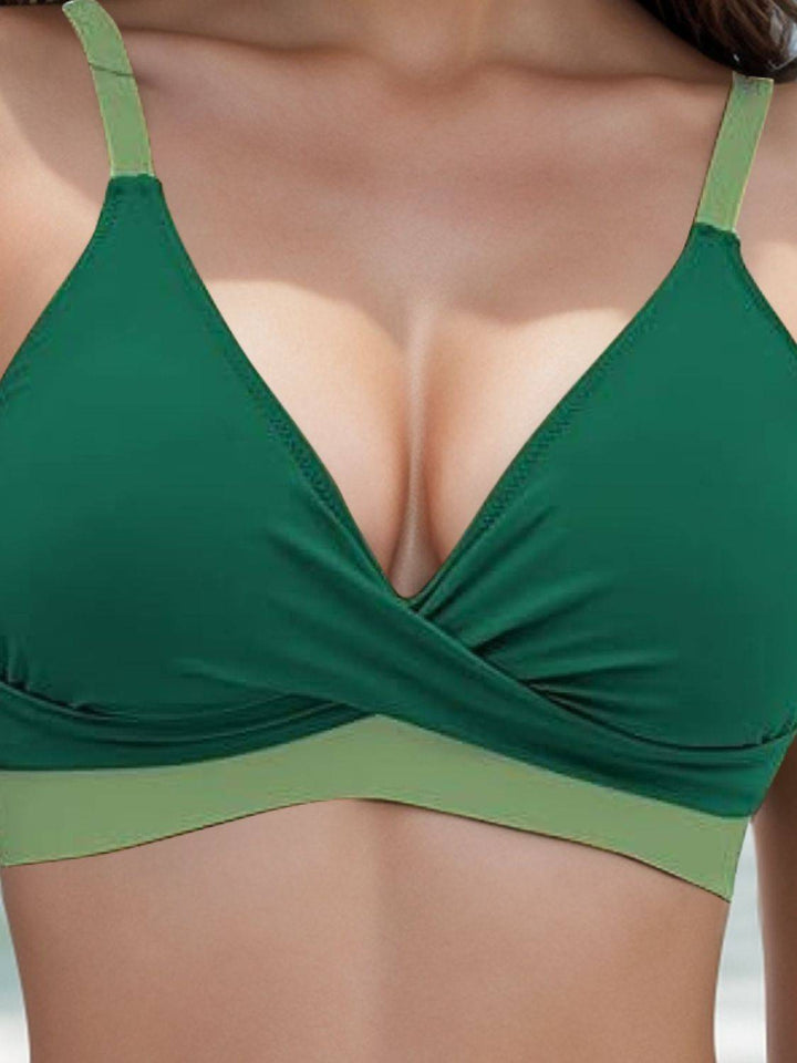 a close up of a woman wearing a green bikini top