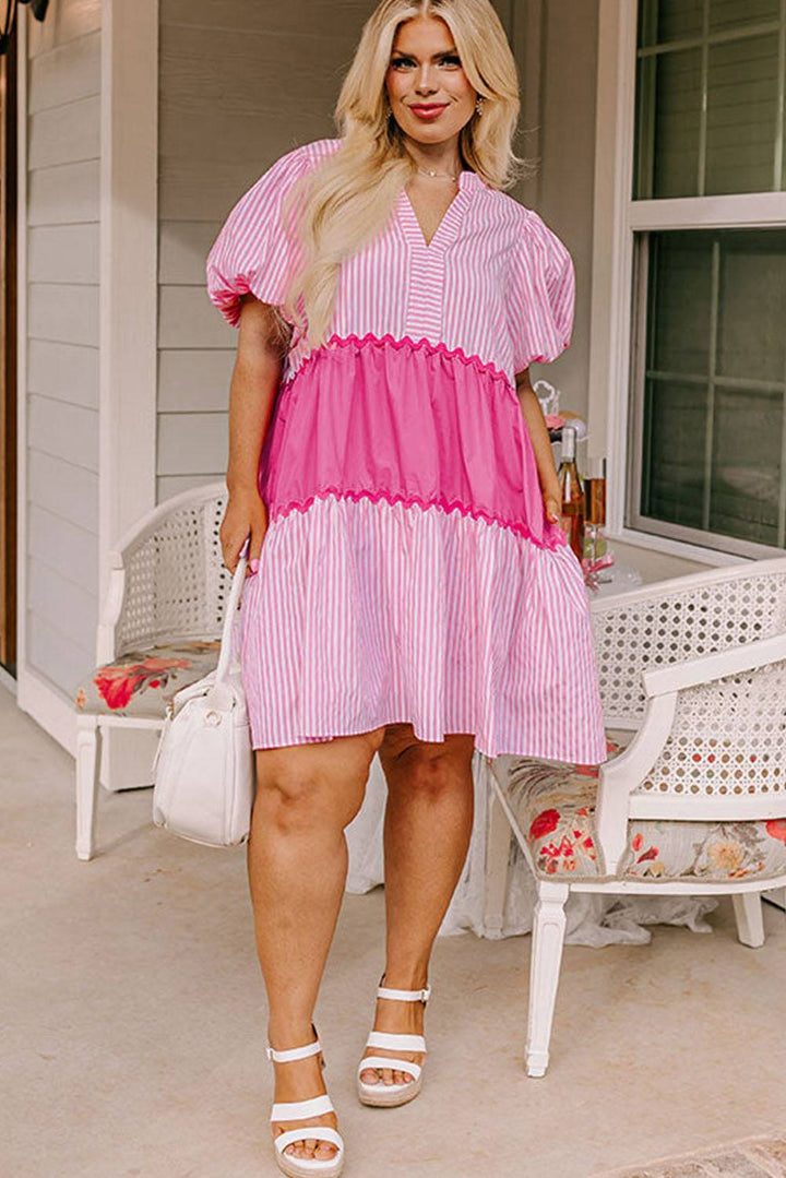 a woman in a pink and white striped dress