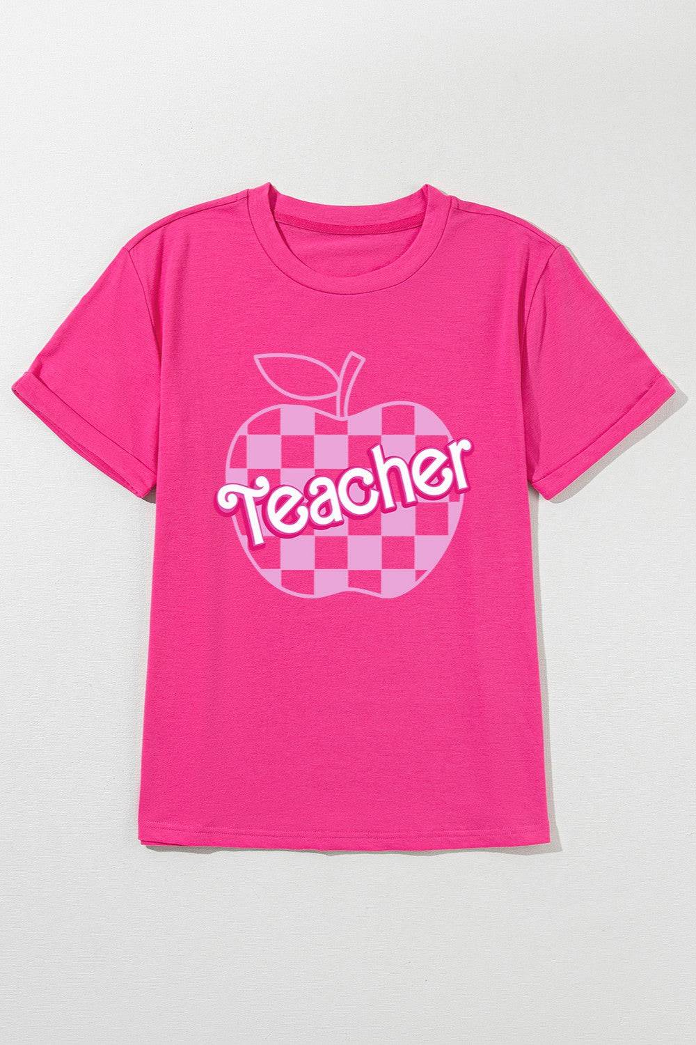 a pink shirt with a checkered apple on it