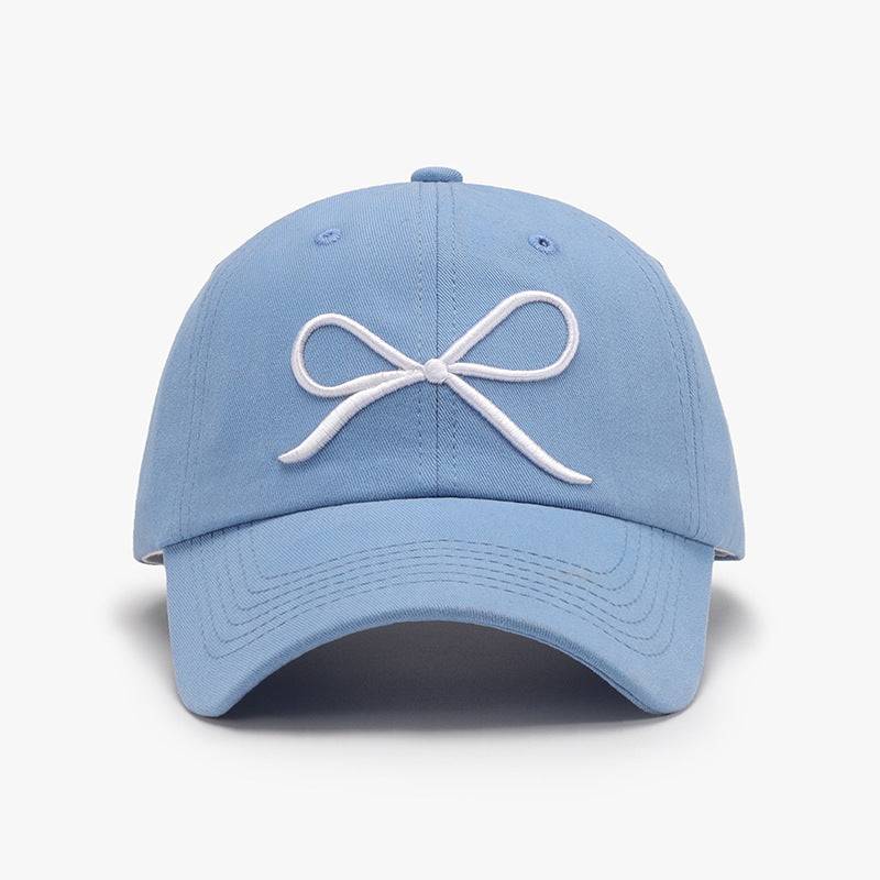 a light blue hat with a white bow on it
