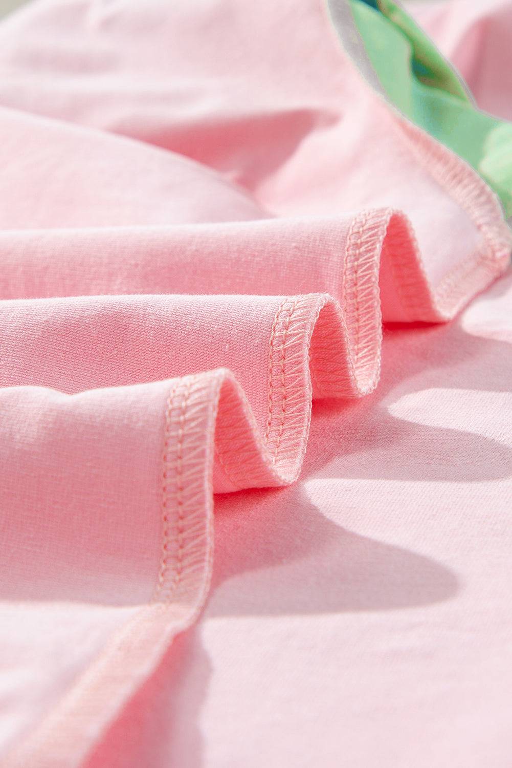 a close up of a pink shirt with a green tie