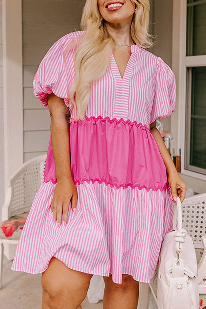 a woman in a pink and white striped dress