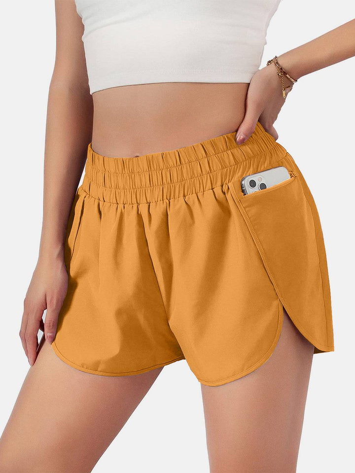 a woman wearing a pair of shorts with a cell phone in her pocket