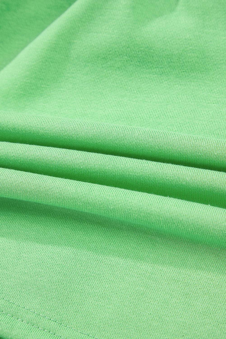 Close-up of soft French Terry fabric in light green, highlighting texture and material quality of mini skort at Faith & Co. Boutique.
