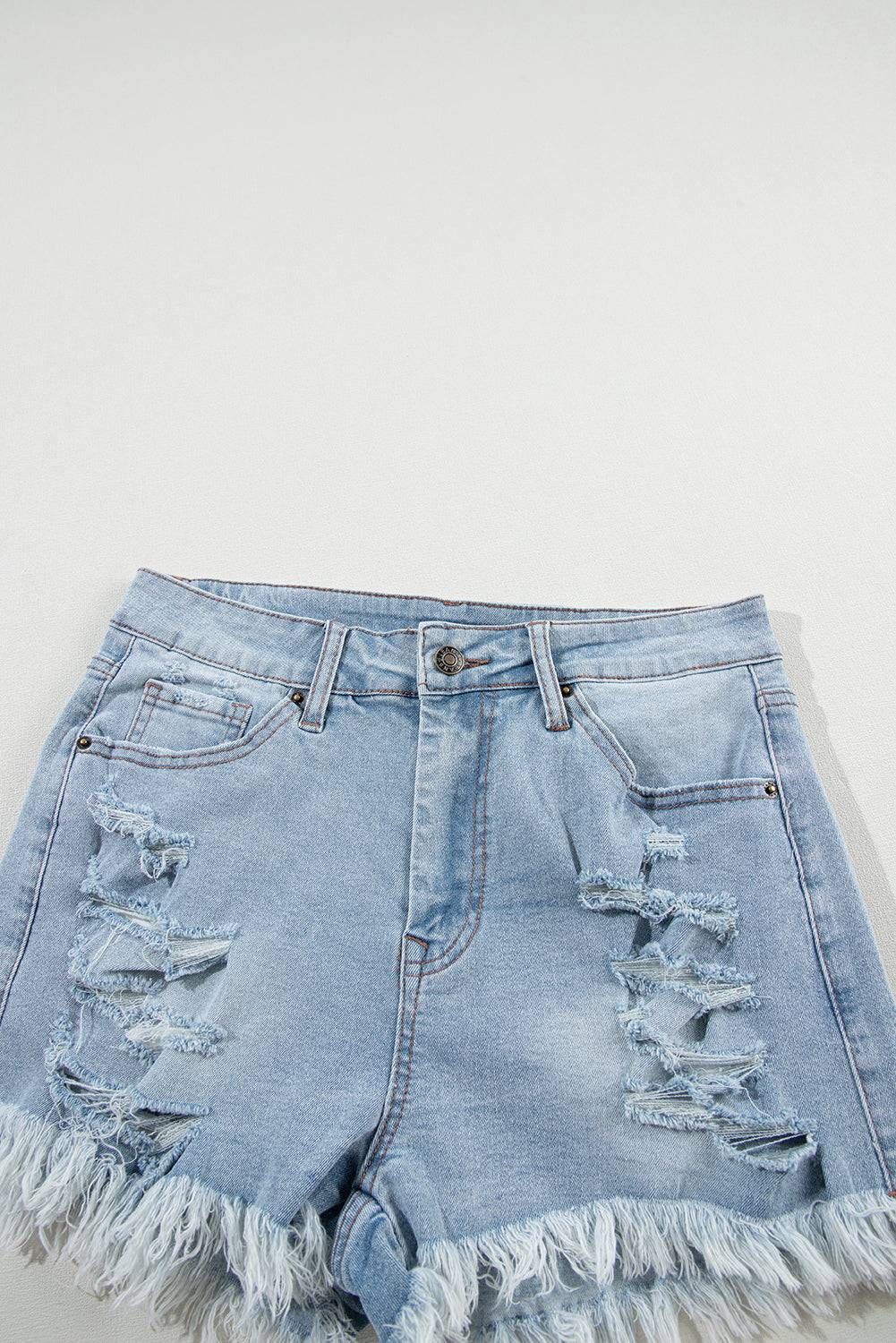 a pair of light blue jean shorts with frays