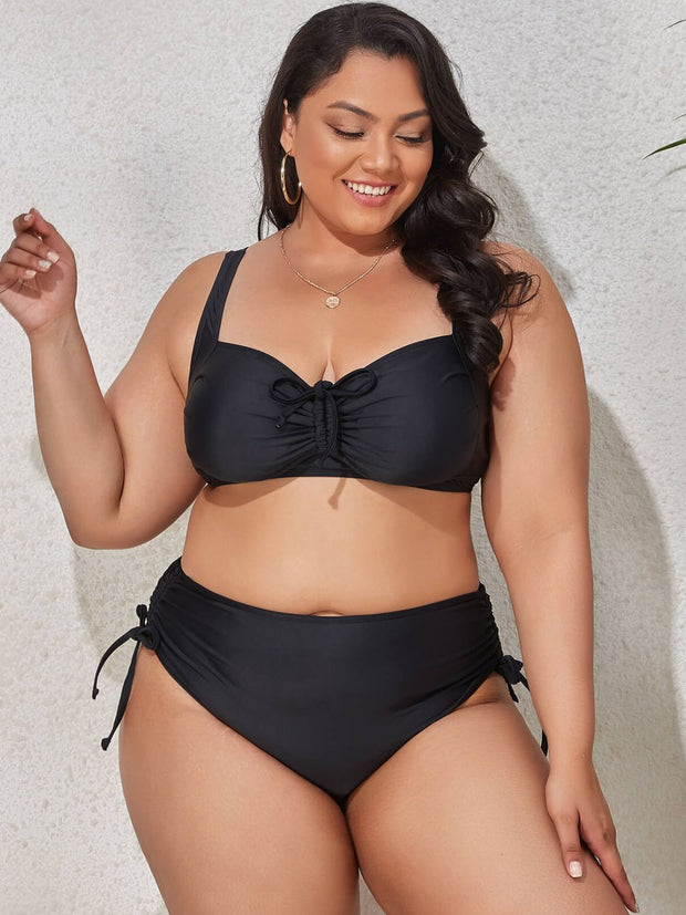 a woman in a black bikini top and bottom