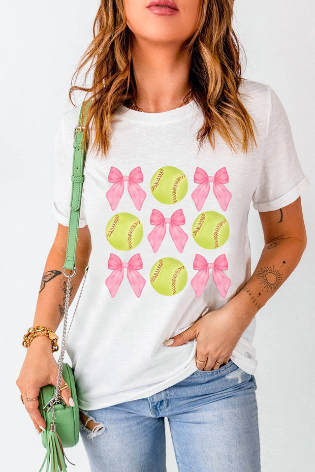 a woman wearing a t - shirt with bows and softballs on it